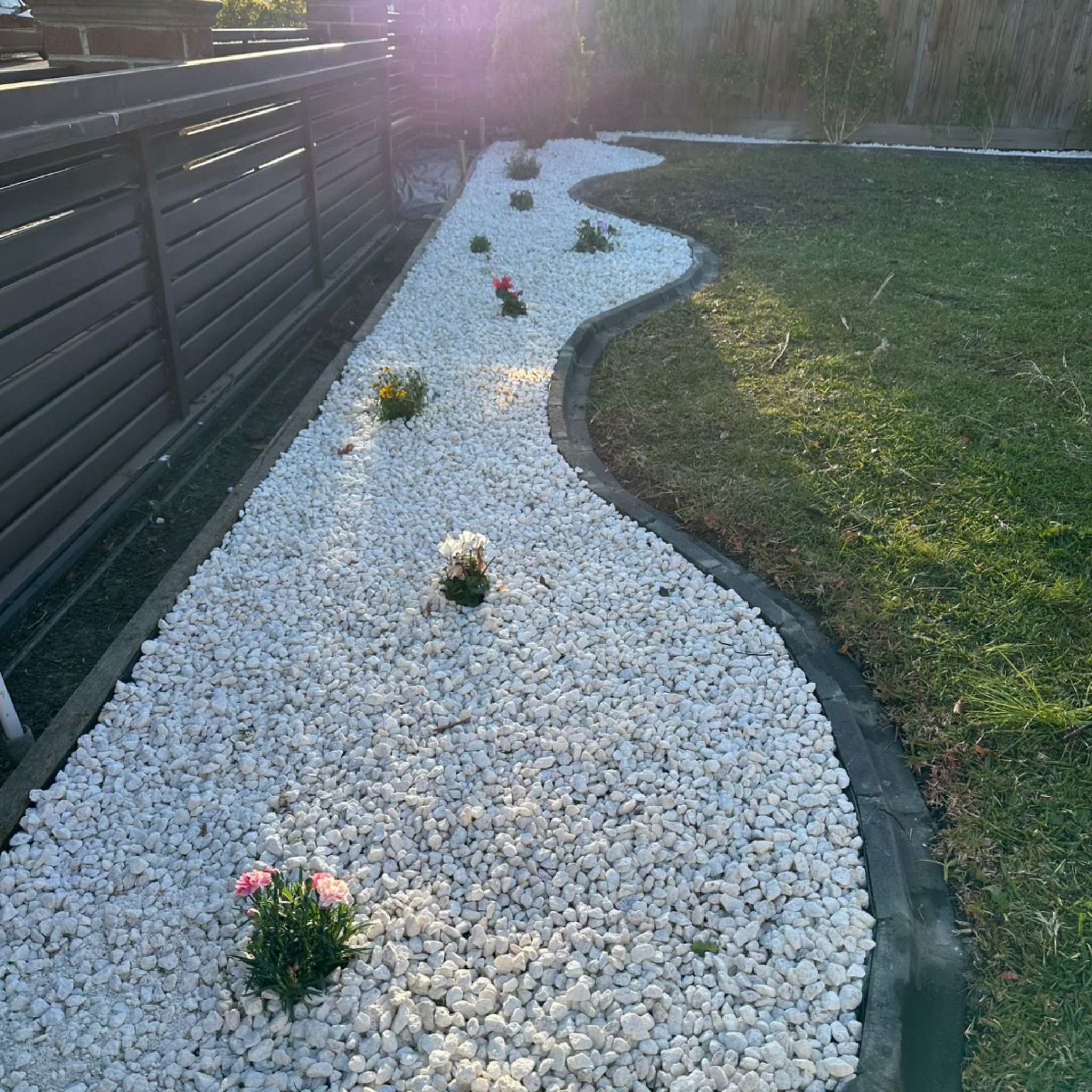 Landscaped pebble creek bed feature