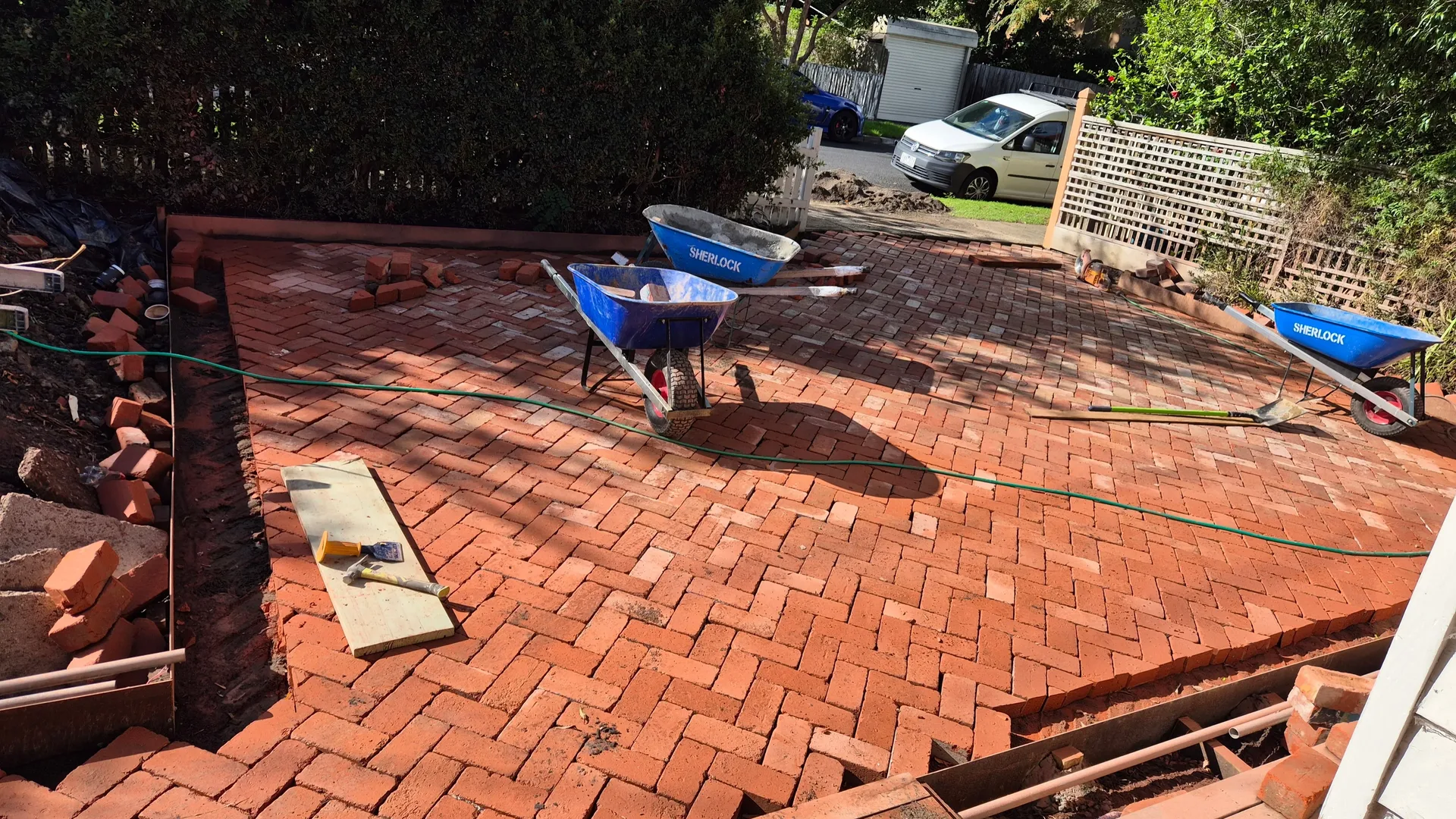Wide view of brick herringbone patio construction