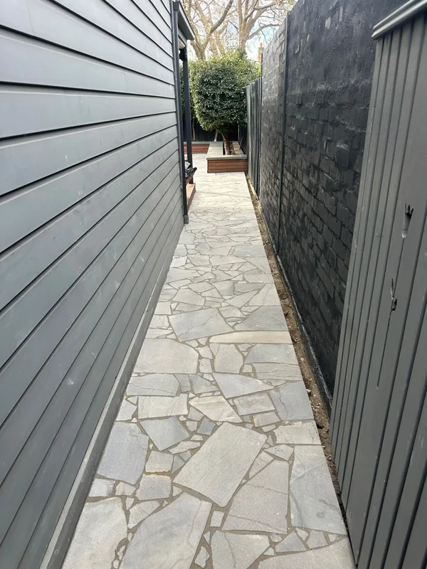 Bluestone crazy paving side path along a weatherboard home
