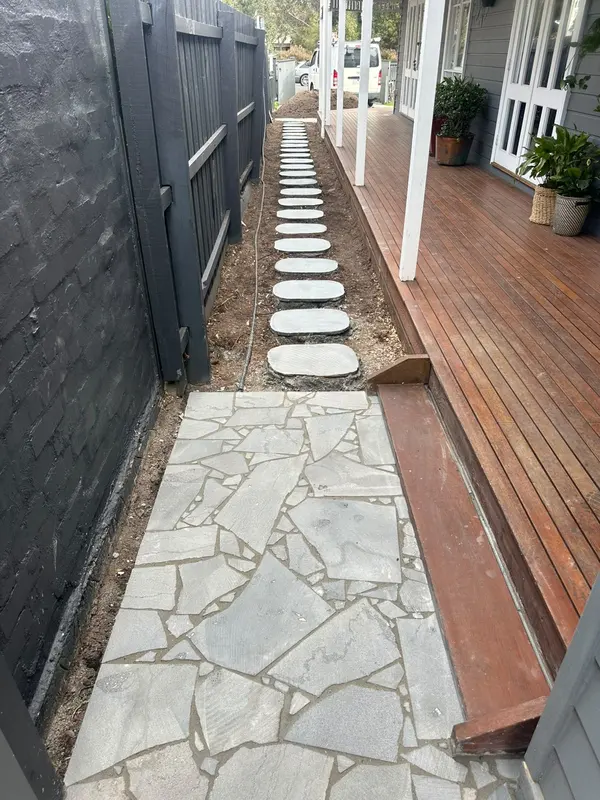 Bluestone stepping stones beside a deck