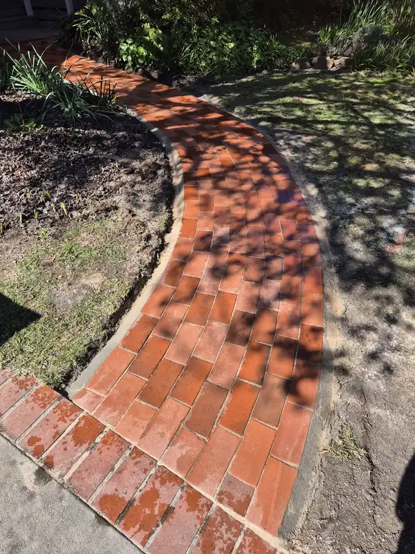 Detail of a curved brick garden path with neat cuts