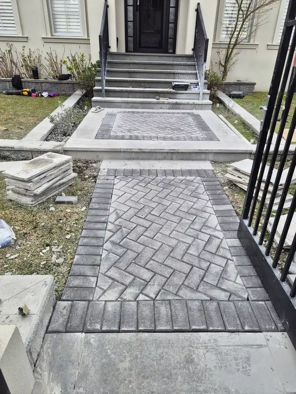 Charcoal brick pavers laid in herringbone along a side path