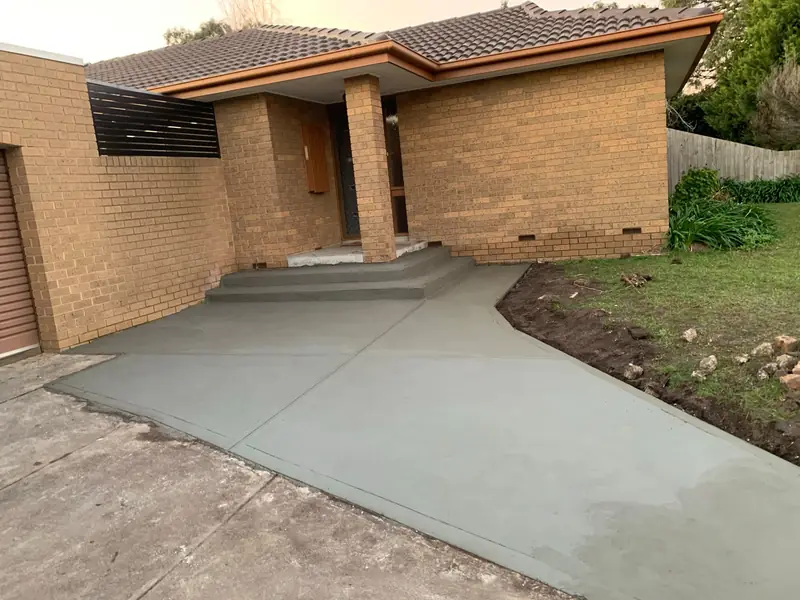 Concrete front path and step at a brick home