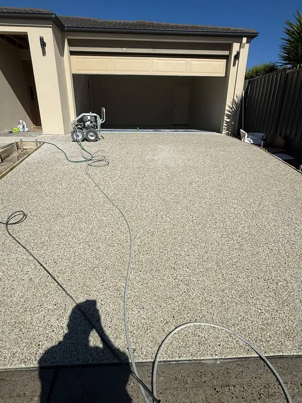 Exposed aggregate driveway leading to a garage