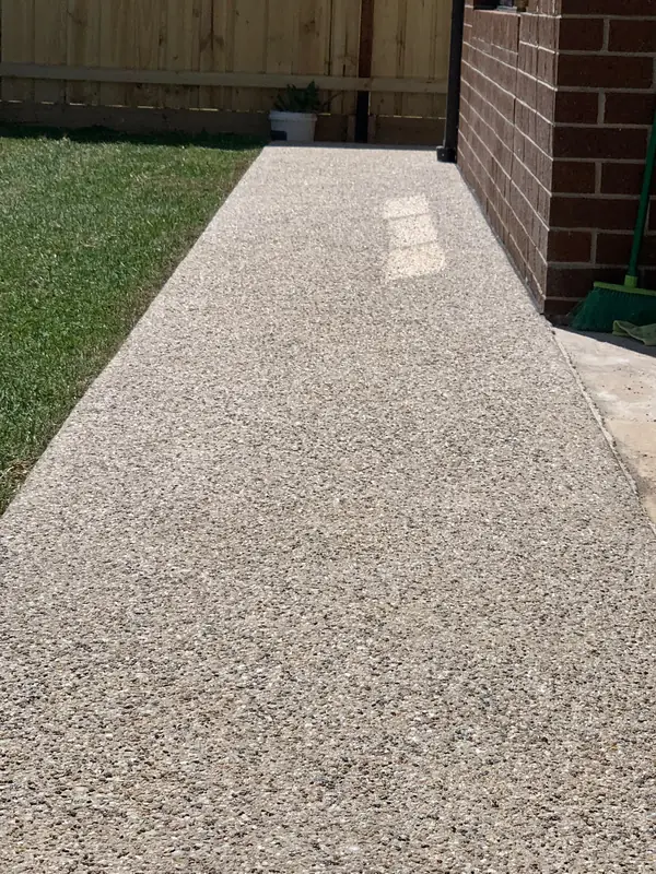 Exposed aggregate path next to a new lawn