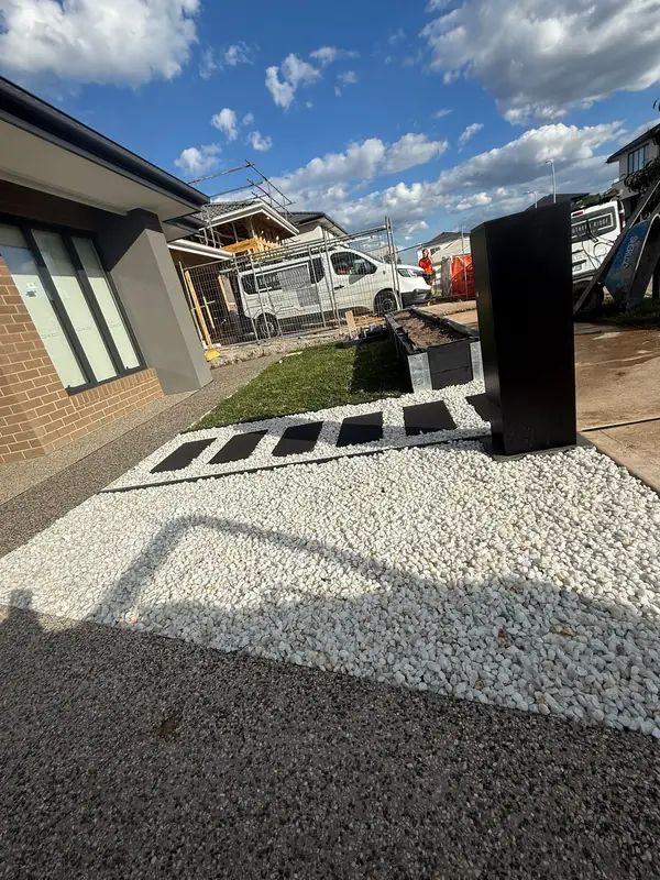 Front garden with white pebbles and stepping pavers