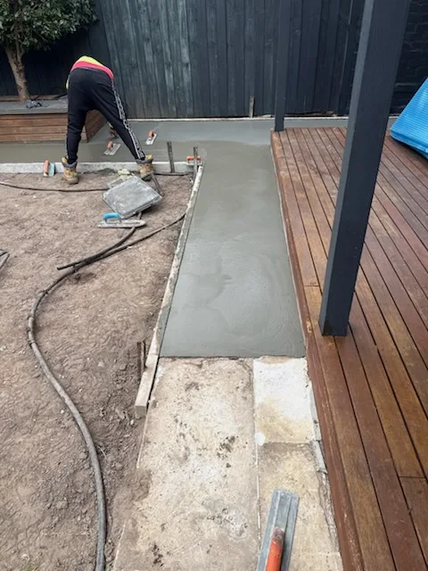 Concrete base poured around a pool ready for paving