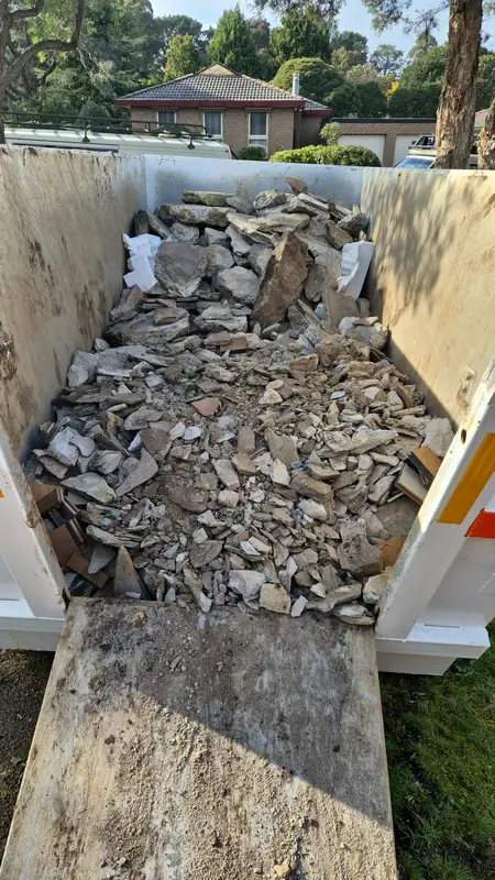 Trailer loaded with old paving rubble being removed from site