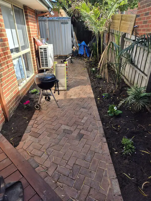Recycled brick paving meeting a garden bed