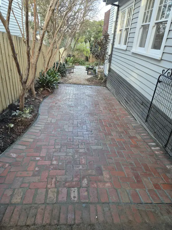Recycled brick side path beside a brick home
