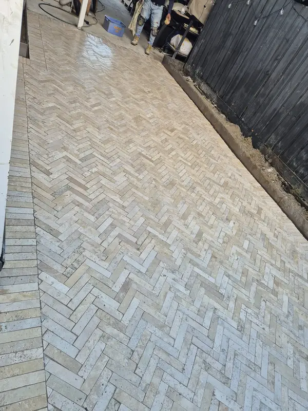 Travertine pavers laid in a herringbone pattern