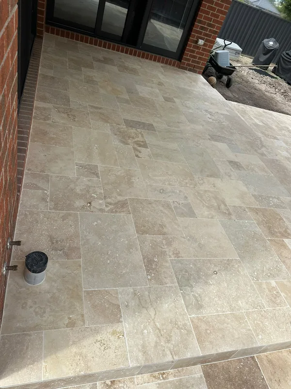 Travertine alfresco outdoor area under a covered entertaining space
