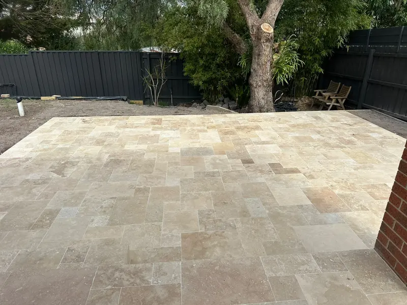 Large travertine French pattern patio in a Melbourne backyard