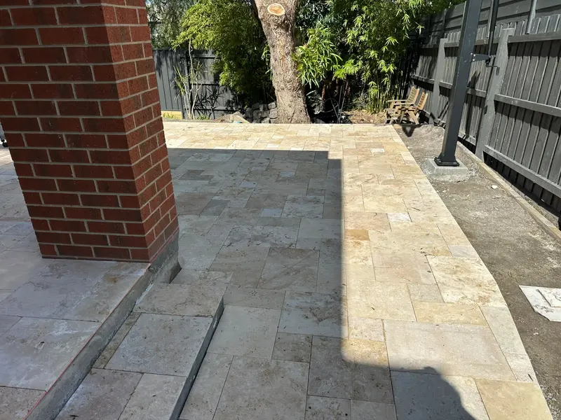 Travertine paving with a neat step edge at an alfresco area