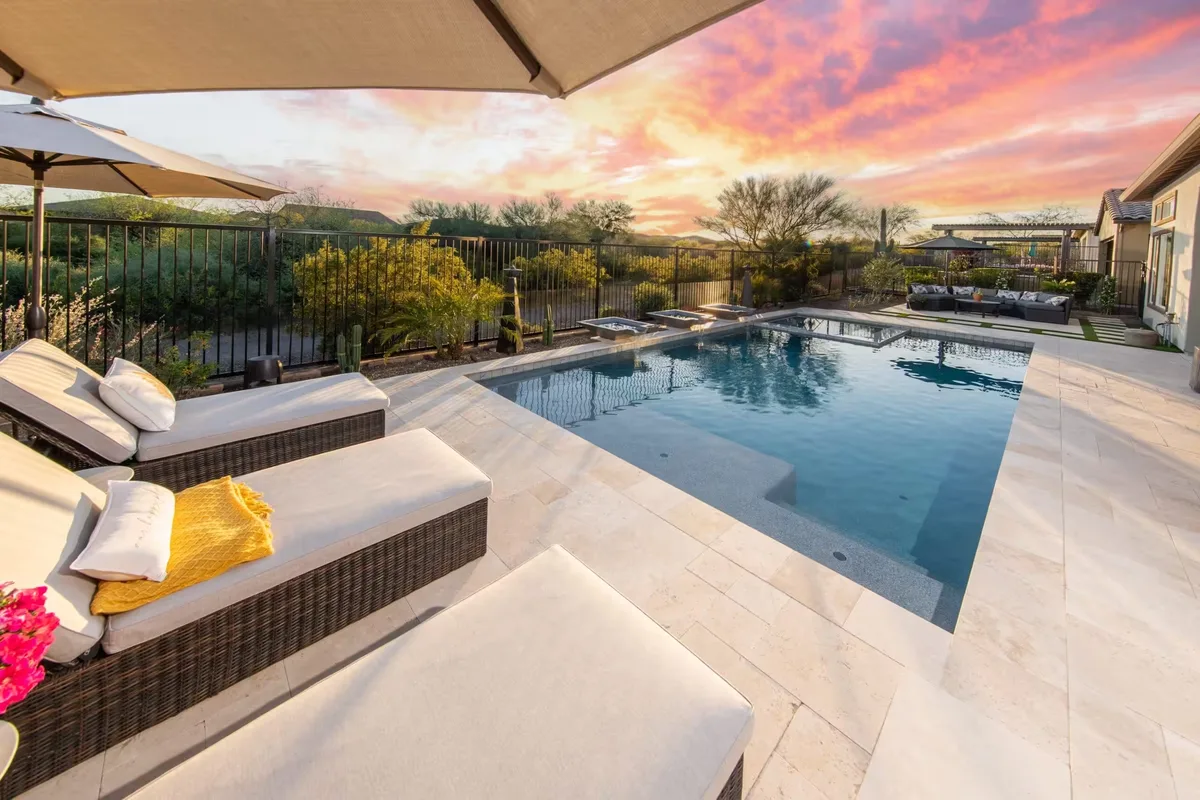 Pool paving travertine surround with sun loungers sunset Melbourne by Antonio PrimeScape