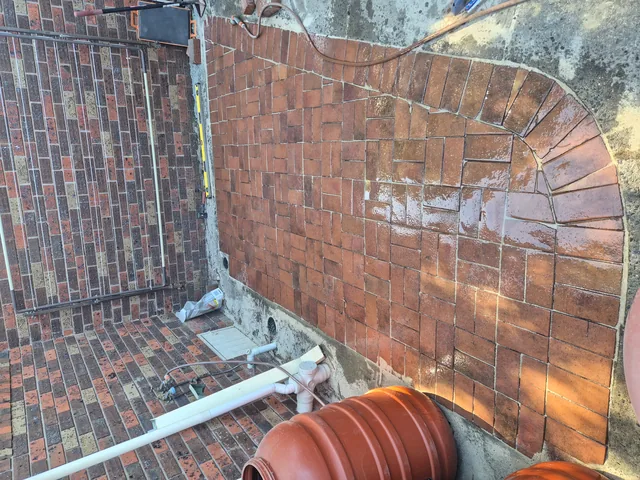 Curved brick herringbone patio paving — Antonio PrimeScape Construction