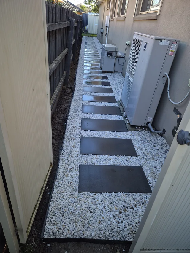 Modern paver stepping path with pebble border — Antonio PrimeScape Construction