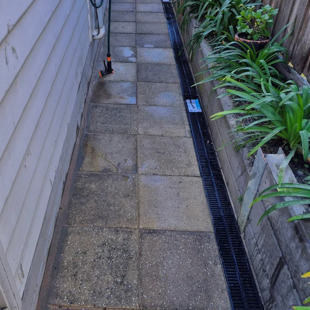 Paved side path beside a garden bed — Antonio PrimeScape Construction